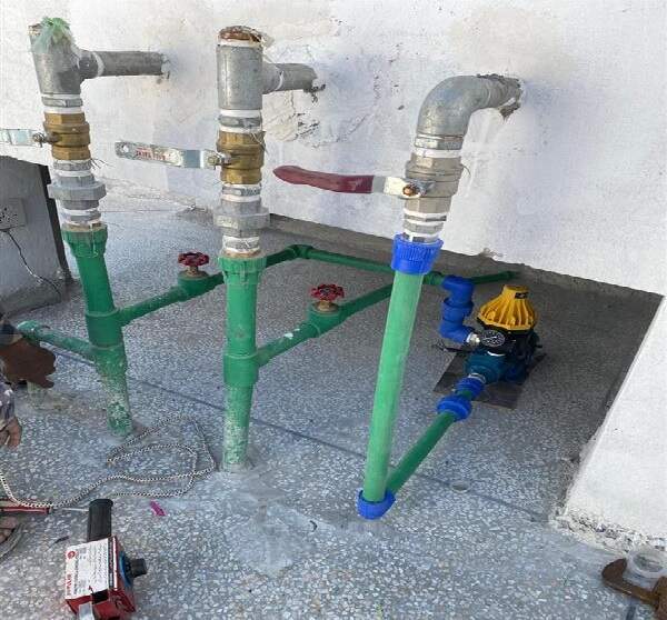 Plumber repairing pipe leakage in Islamabad home