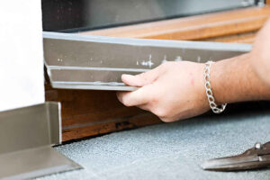 Handyman Installing a door sweep